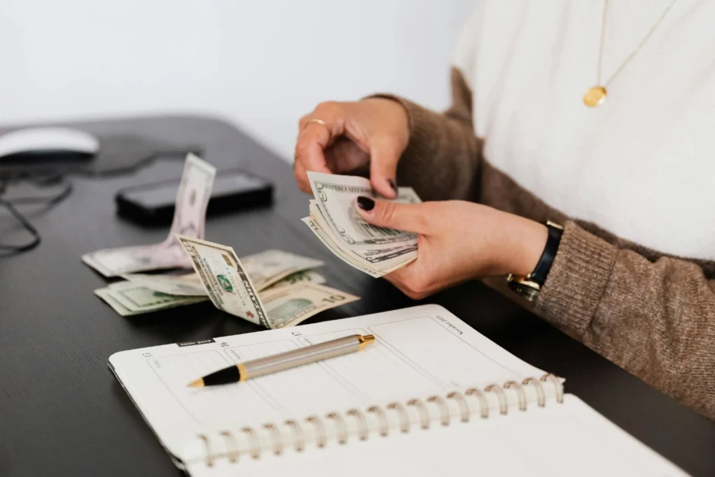 a woman counting money to tip movers