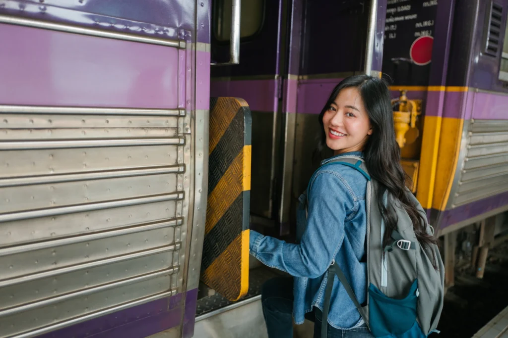 young woman boarding MBTA commuter rail from Worcester to Boston